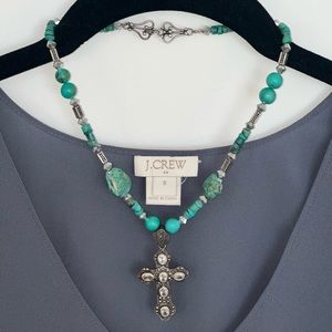 Turquoise beaded cross necklace.